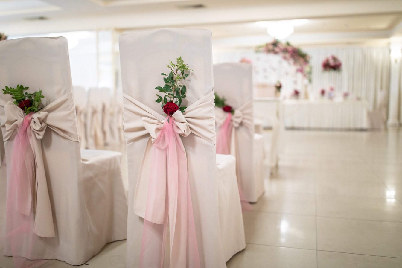 Chairs decorated with flowers at banquet hall