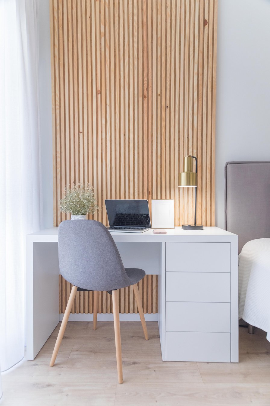 Laptop and Lamp on Top of a White Table with Chair 